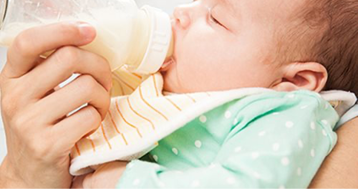 A baby drinking milk from a bottle