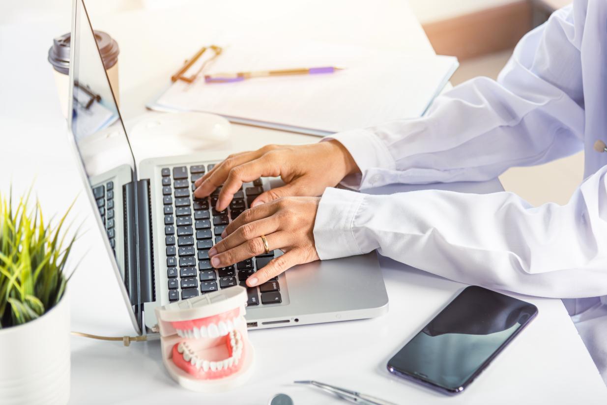  A person typing on a laptop at a desk