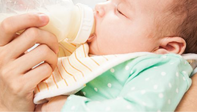 A baby drinking milk from a bottle