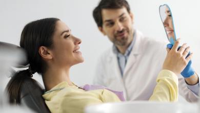 Woman looking in mirror at dentist