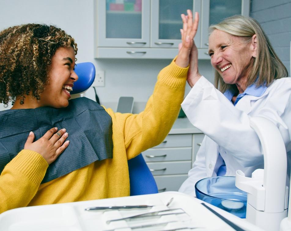 a woman high fives her dentist